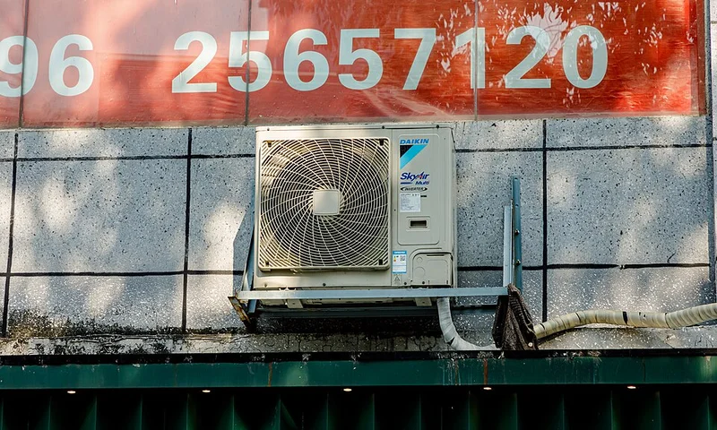 Outdoor heat pump condenser beside a home