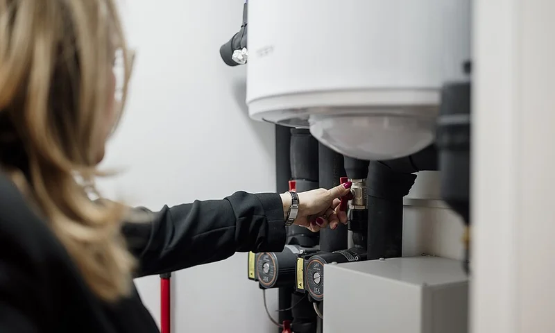 Technician servicing residential HVAC equipment